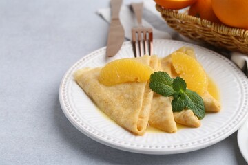 Delicious Crepes Suzette served on light table, closeup