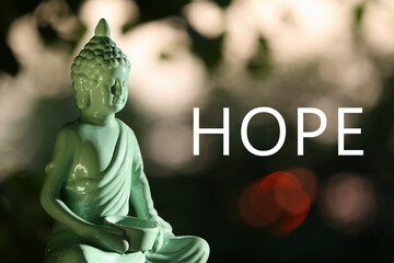Hope. Decorative Buddha statue on blurred background