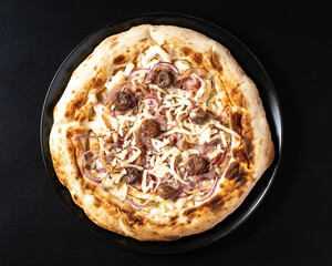 top view pizza with onions, bacon and chestnuts, on black background