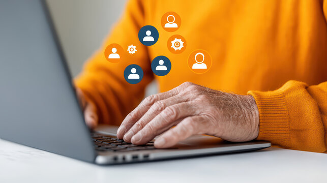 close up of elderly man using laptop, engaged in virtual communication. warm orange sweater adds cozy touch to scene