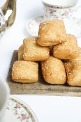 Odading, a box-shaped fried bread that expands like a pillow, with a like brown crispy outer shell and sprinkled with sesame seeds. bright mood style. perfect for article of catalogue