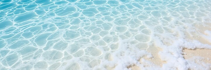 Obraz premium Crystal clear turquoise ocean water with white foamy waves crashing against the shore, creating a serene and refreshing texture underneath the sunny skies, foam, beach, foam