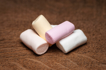 Marshmallow. A pile of marshmallows on a wooden surface. Selective focus