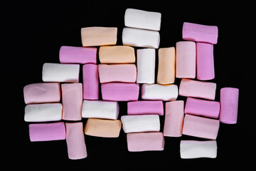 Marshmallow. Heap of colored marshmallows on a black . Top view
