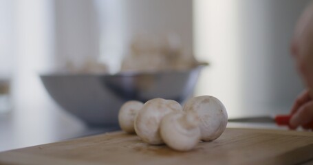 Chef Puts Fresh Mushrooms on Chopping Board