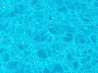 Obraz premium Blue water wave texture background with ripples and reflections, ocean, aqua