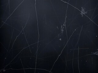 Gritty, distressed black surface layered with grunge textures and scratches, art, worn