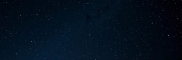 Night sky filled with sparkling stars against a black background, starlit, panoramic