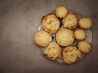 Delicious round vatrushka buns with cottage cheese filling on glass plate copy space