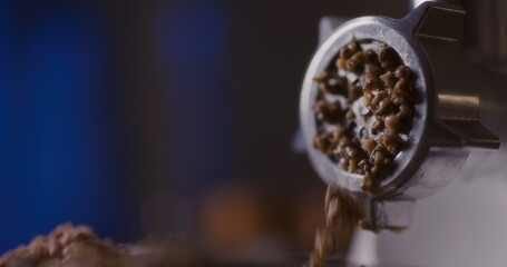 Obraz premium Fresh minced meat coming out of the mincer opening