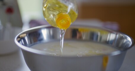 Pouring Oil Into Bowl Preparing Dough for Baking Bread