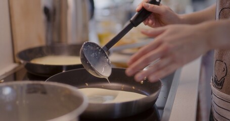 Pouring Pancake Batter into Pan While Frying