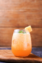 melon juice in a glass, on a wooden background. healthy drink.