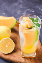 Melon juice, lemonade in a glass with ice and melon slices decorated with mint leaves. Fresh summer drink concept. Ramadan -kareem.