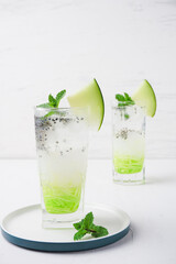 ice melon nata de coco, a drink with a cold sweet taste consisting of a mixture of melon syrup, melon fruit, nata de coco, basil seeds and soda