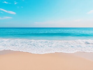 Fototapeta premium A serene beach scene with gentle waves lapping at the shore under a clear blue sky.