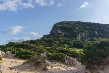 Idyllic landscape of rock formation at Gialova Lagoon besides voidokilia beach on a sunny spring day, Messinia, Peloponnese, Greece