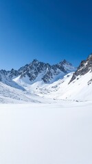 Snowy mountain range reflected in a frozen lake under a clear blue sky.