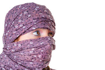 profile of young girl with big green eyes looking to the side with a scarf on her head