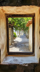 A picturesque view through a window framing a serene walkway lined with greenery.