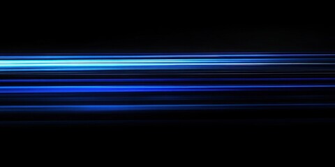 Abstract blue light streaks on black background.