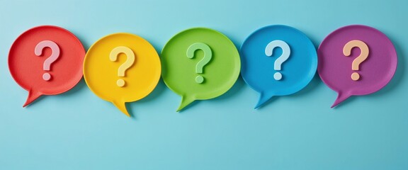 Colorful question marks in speech bubbles on a light blue background, symbolizing communication and curiosity.