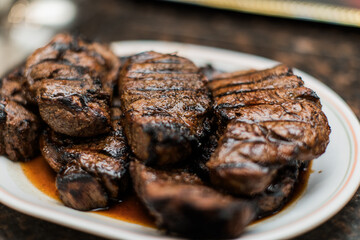 A plate of grilled steak filet mignon on the table 