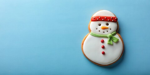 Fototapeta premium Tasty Christmas cookie in shape of snowman on light blue background, top view, winter, holiday, festive, cute