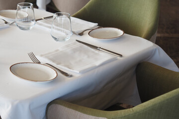 An Elegant Dining Table Setting Complemented by Stylish Green Accent Chairs