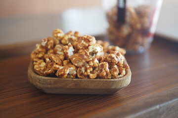 Enjoy savoring the delicious flavor of Caramel Popcorn in a Wooden Bowl