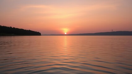 A peaceful sunset over a calm lake with vibrant orange and pink hues reflecting on the water, outdoors, water, sunset