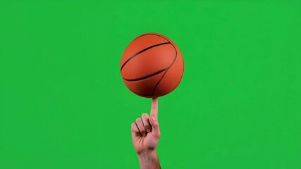 a basketball rotating on it's axis on green background - Powered by Adobe