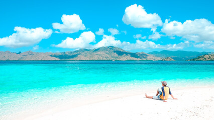 traveler enjoys vacation in sandbank islands with color gradient water at the tropical beach