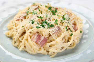 Delicious pasta Carbonara with bacon on plate, closeup