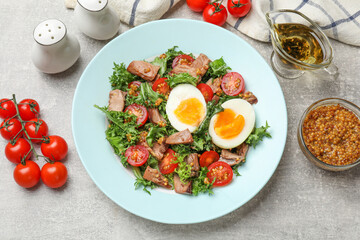 Delicious fresh tuna salad and ingredients on grey textured table, flat lay