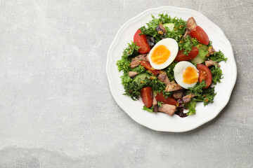 Delicious fresh tuna salad on grey textured table, top view. Space for text