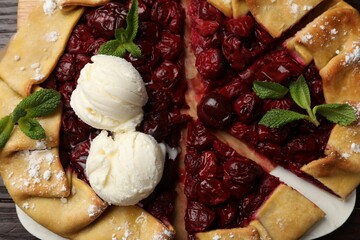 Tasty galette with cherries and ice cream on table, flat lay