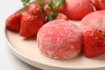 Delicious mochi, strawberries and mint on light table, closeup