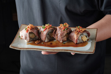 Grilled Beef Sushi Roll with Sauce on Plate