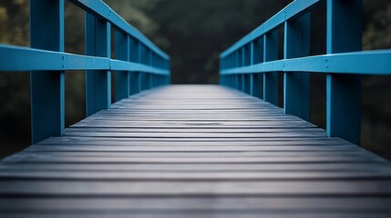 A bridge with a blue railing and a wooden walkway