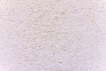 Texture of a white plaster wall revealing subtle details and variations