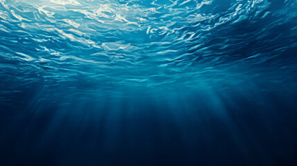 Underwater view showcasing sunlight filtering through ocean waves. 