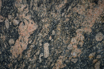 Close-up view of granite rock face, highlighting natural texture and mineral composition