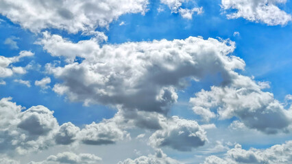 Bright blue sky and thick white clouds. Beautiful white clouds in bright blue sky as nature concept.