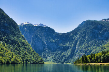 Beautiful mountains and lake by a boat dock at Konigssee in Germany  on a sunny spring day.