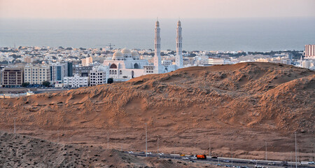 Muscat, Oman - capital and most populated city in Oman, Muscat displays amazing spots where its white buildings are surrounded by impressive mountains and rock formations	