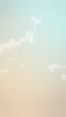 Obraz premium Soft pastel gradient backdrop with fluffy white clouds floating in a clear and open sky, creating a minimalist and tranquil HD phone wallpaper 