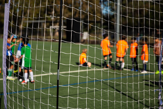 kids getting ready to play a football game on a sunny morning