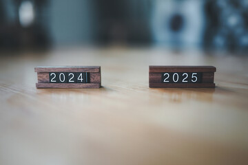 Starting new year 2025. Flipping of 2024 to 2025 on wooden cube blocks. Beginning and start of the new year 2024. target and strategy concept.	
