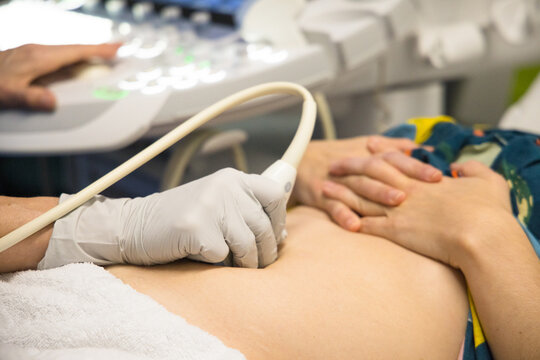A female having an ultrasound performed on her abdomen